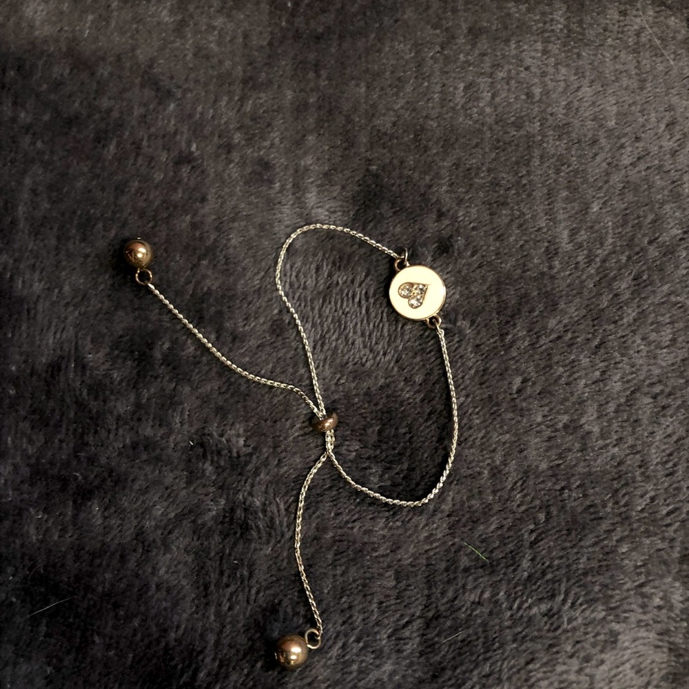 SOLD!!!!goldish silver bracket with a heart NOT a necklace